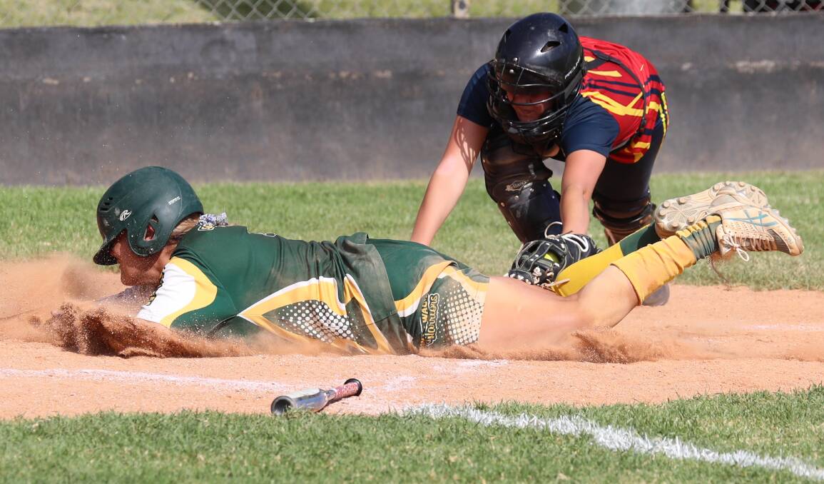 FLYING FINISH: South Wagga's Montana Kearnes dives for home base as Turvey Park catcher Kalee Gibbons attempts the tag. Picture: Les Smith
