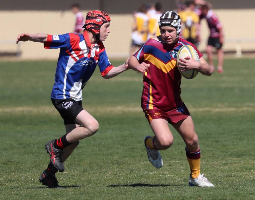 RISING STARS: McAuley Central School's Hamish Plum prepares to tackle Mater Dei Catholic College's Isaac Hardman during the tournament. Picture: Les Smith