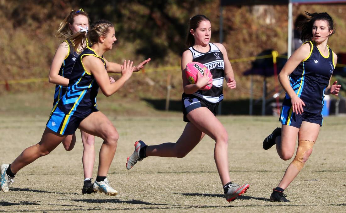 STRIDING AWAY: Maddy McPherson charges through a gap for Riverina against South Coast during day one of the NSWCHSSA secondary touch football championships in Wagga. Picture: Emma Hillier