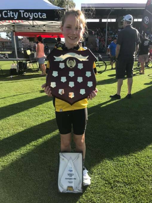 SUPER CYCLIST: Carrington Oke, 8, with her J9 division winners trophy and shield after junior state championships last weekend. Picture: Supplied