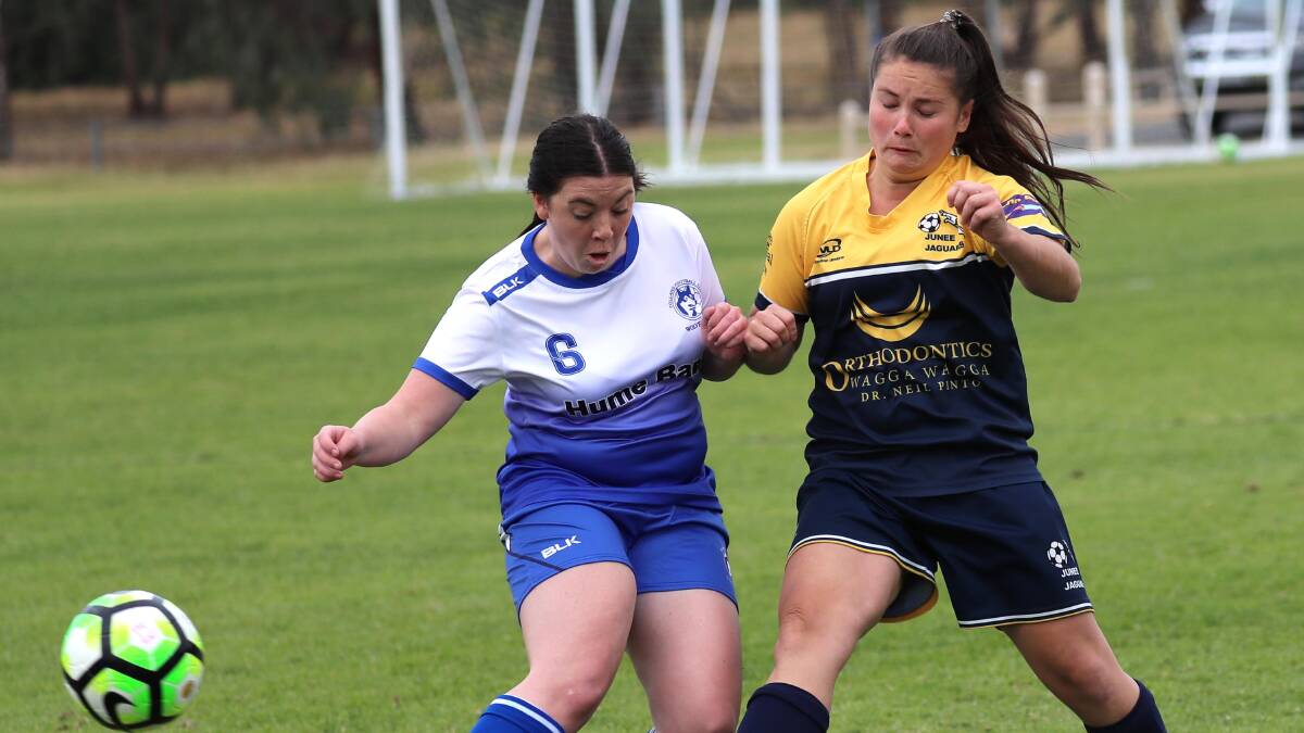 COLLISION COURSE: Tolland's Meg Thompson wrangles with Junee's Abby Foley during an earlier Leonard Cup. Tolland defeated Junee 3-2 in Sunday's preliminary final. Picture: Les Smith