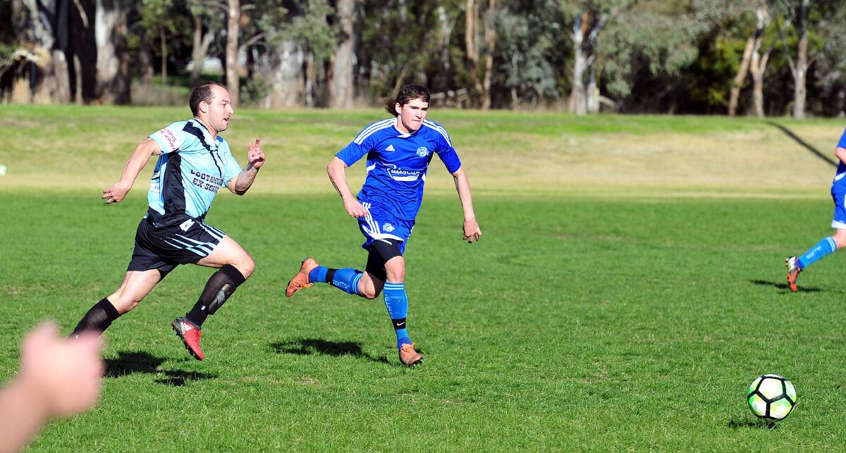 RACING AHEAD: Cootamundra striker Aaron Kemp and Tolland star Jaiden O'Brien charge towards the ball during a 2017 Pascoe Cup clash. 