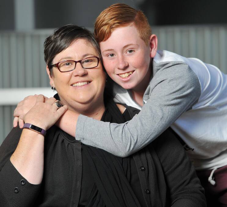 NOMINATED: Isaac Cornell (right, pictured with mum Tracey in 2016) has been recognised for his services to local sport and charity.