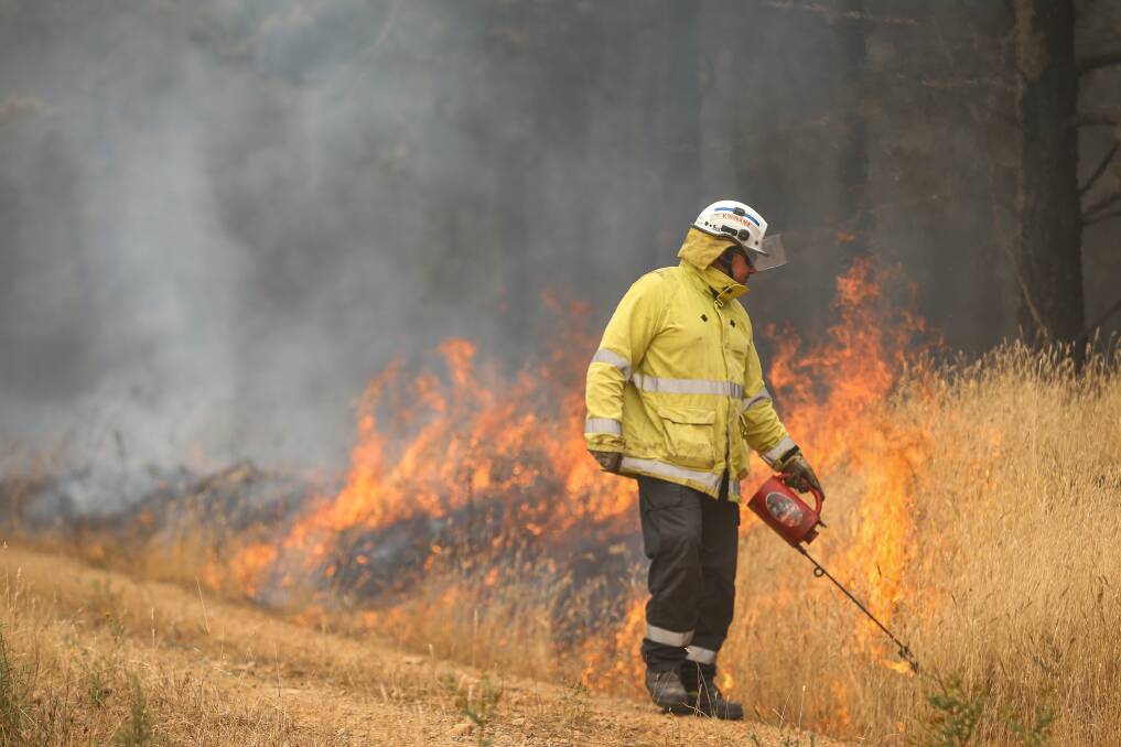 FLAMES: The West Australian Strike Team were a part of some back burning north of Jingellic yesterday aiming to strengthen containment lines. Pictures: JAMES WILTSHIRE