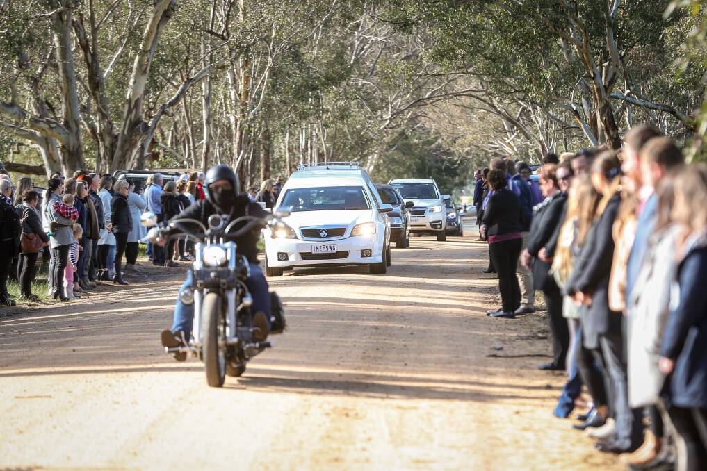 FAREWELL: More than 500 people lined Pioneer Drive in Jindera to give Jack Williams a guard of honour as the hearse drove to the cemetery. Picture: JAMES WILTSHIRE