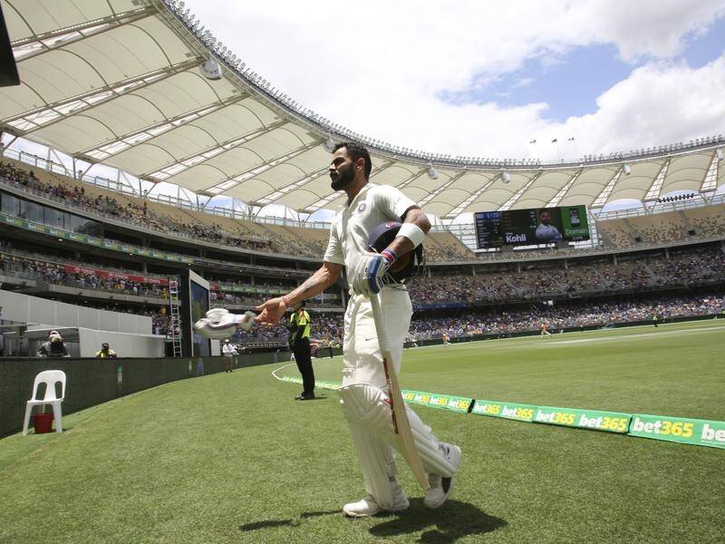An unhappy Virat Kohli throws a glove as he walks off after his controversial 2nd Test dismissal.