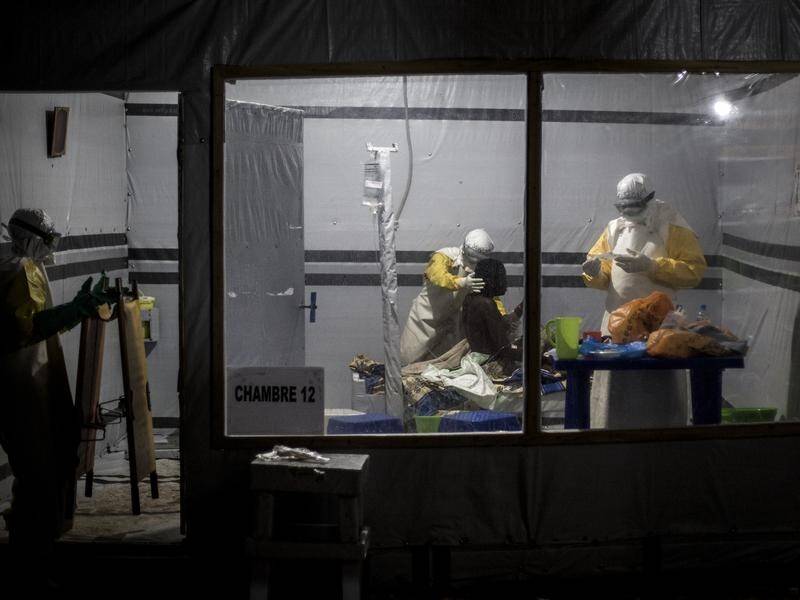 Health workers treat a suspected Ebola patient in Congo, which is also facing years of fighting.