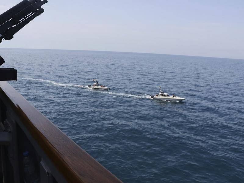 A US Navy picture shows Iranian vessels sailing close to US Navy ships near Kuwait last week.