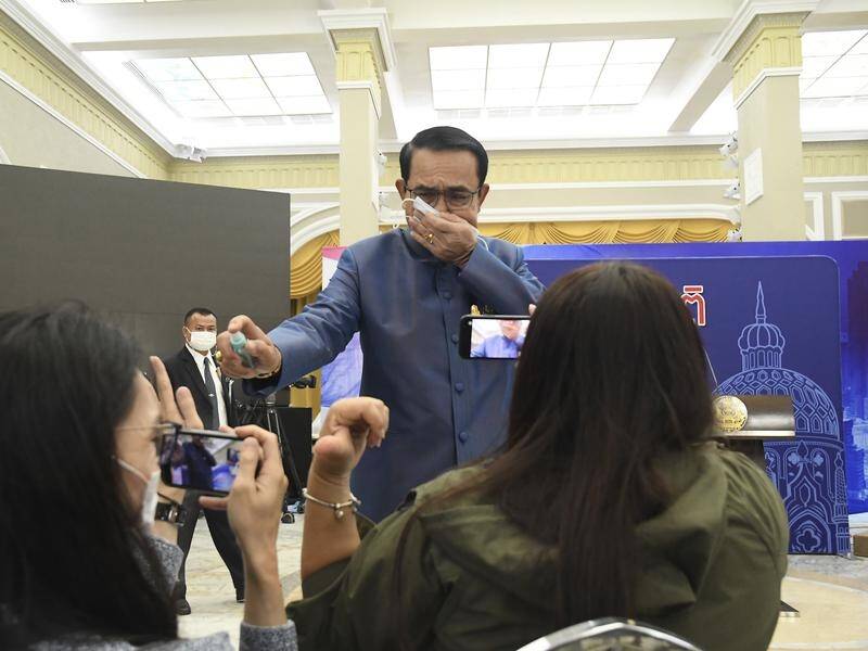 Thai Prime Minister Prayuth Chan-ocha has sprayed a front row of reporters with hand sanitiser.