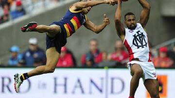 Heritier Lumumba (r) says he is moving on from his racism dispute with his former club Collingwood.