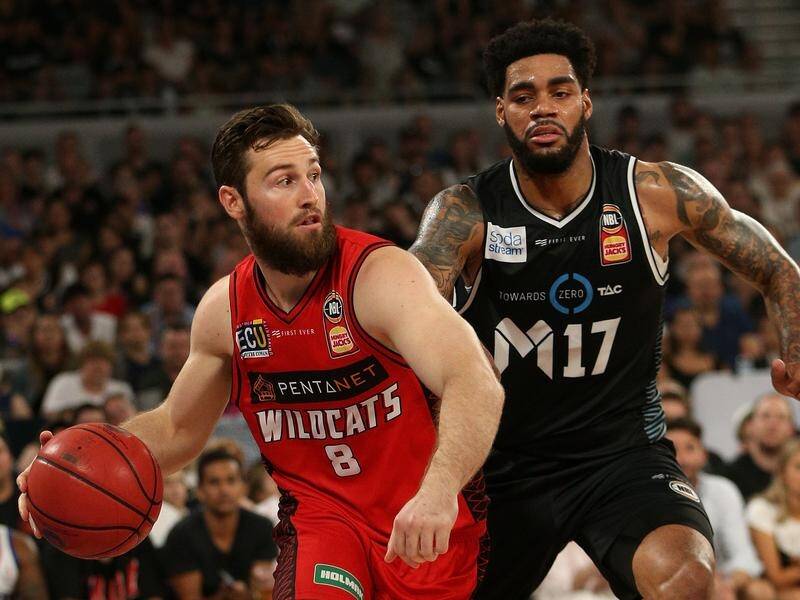 Mitch Norton of Perth (L) is tailed by Melbourne's DJ Kennedy in their NBL grand final series game.