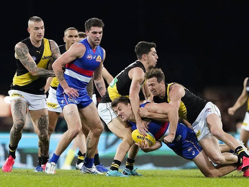Western Bulldogs' Jack Macrae tried to get the ball away under pressure against Richmond.