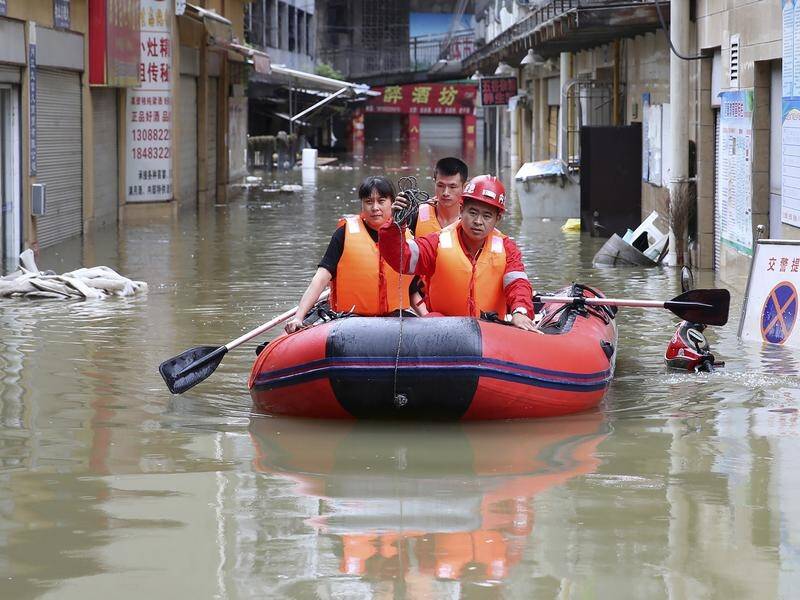 Rescuers in a flooded neighbourhood in Neijiang in southwestern China's Sichuan Province.