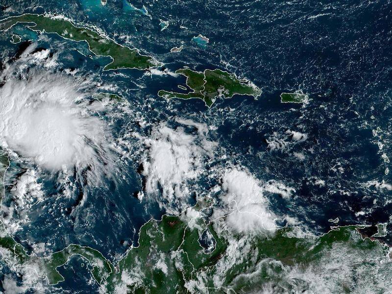 Hurricane Lisa, now a storm) had been forecast to cross Belize into Guatemala and then into Mexico. (AP PHOTO)