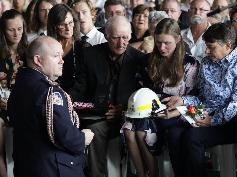 NSW Fire Commissioner Shane Fitzsimmons presenting the commendation to Sam Mcpaul's widow Megan.