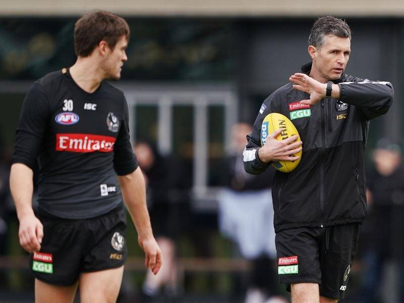 Collingwood assistant Justin Longmuir (R) is still in the mix for the vacant Dockers' coaching role.