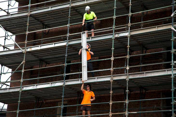 Generic construction, housing, residential property, high density living, apartment, flat, union, workers, high vis, work safety. Scaffolding is put together in Pyrmont, Sydney, Monday 27th November 2017. photo: Ryan Stuart .