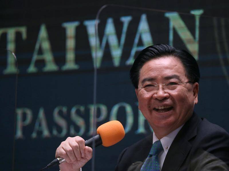 Taiwan Foreign Minister Joseph Wu unveils the new passport design in Taipei.