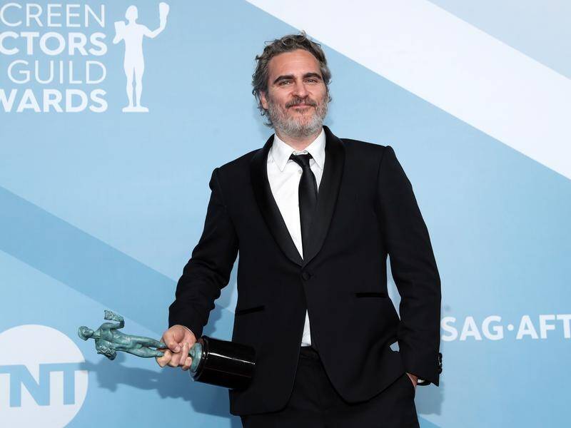 Joaquin Phoenix with his SAG Award for his role in Joker.