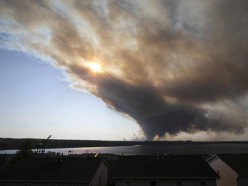 A wildfire in a suburban Halifax, Canada, spread quickly, engulfing homes and forcing evacuations. (AP PHOTO)