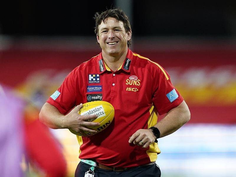 Stuart Dew will remain with Gold Coast for another two years after re-signing with the AFL club.