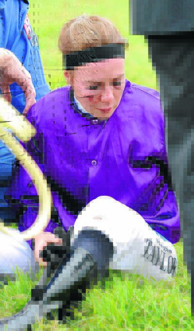 TOUGH: Wagga apprentice Megan Taylor is attended to after being thrown and struck by Rock The Faith at Wagga last Friday. Taylor was taken to hopsital where she was cleared of any serious damage and was given three stitches to the face. Picture: Les Smith