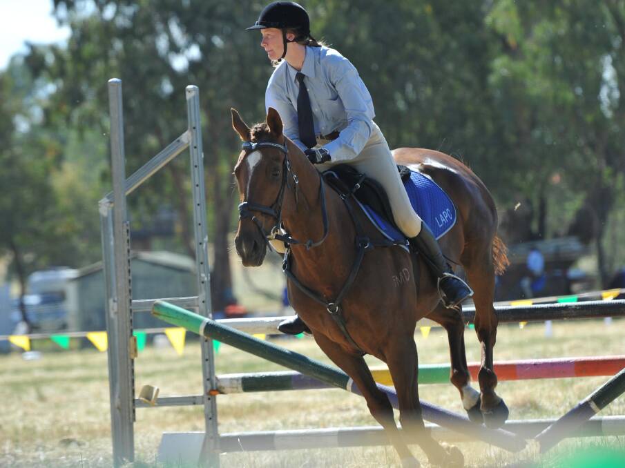SAFE LANDING: Keely O'Hare, 16, completes a jump on Spot The Crown at the Wagga Bidgee Pony Club gymkhana at North Wagga yesterday. Picture: Michael Frogley