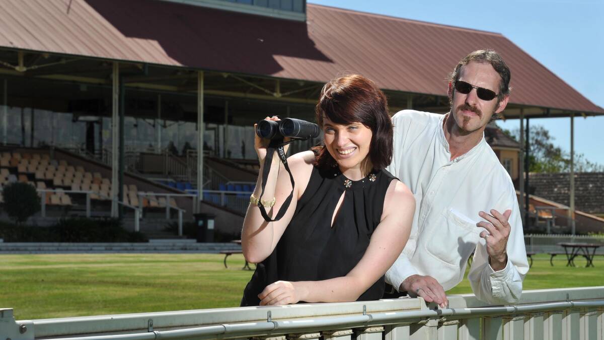 HIGH-STAKES: Stakes associate producers Kate Elizabeth and Ken Hammond act the part at a shoot location at Murrumbidgee Turf Club. Picture: Michael Frogley