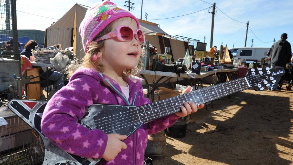 SPIRITED: Three-year-old Lilly Trevaskis-Charlton, of Wagga, is a rock star in a making after collecting a new guitar at the swap meet. Picture: Michael Frogley