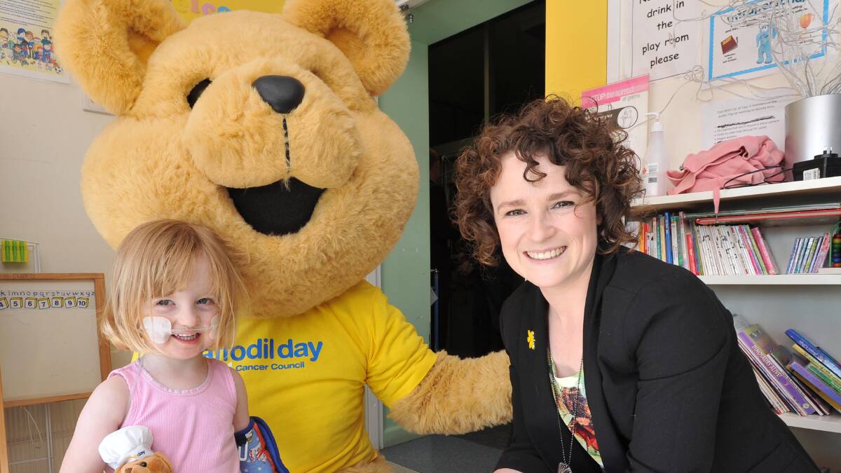 Dougal The Bear, Grace Dunn, 3, and 93.1 Star FM radio host Pip Enscoe
 warm up for Daffodil Day at the Wagga Base Hospital. Picture: Laura Hardwick