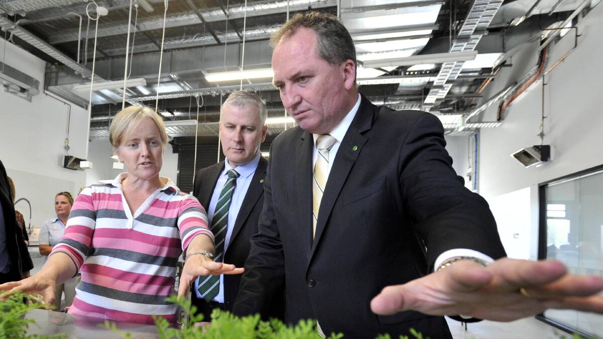 Charles Sturt University research fellow Belinda Hackney shows member for Riverina Michael McCormack and Agriculture Minister Barnaby Joyce some seeded legumes during the pair's visit to the university's Graham Centre for Agricultural Innovation on Thursday. Picture: Les Smith