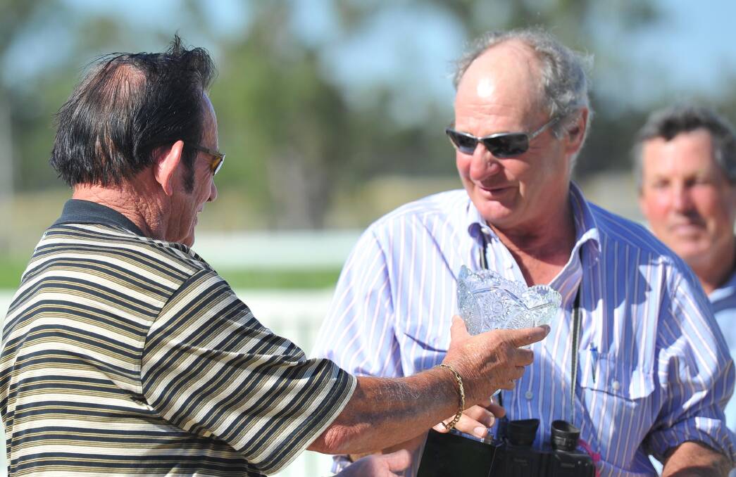 Former trainer, now owner, David Middleton accepts the winnings from Baltra's 2012 Stan Sadlier Stakes victory at the MTC