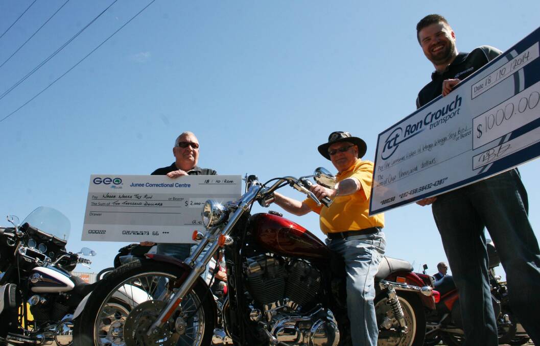 Toy Run Committee president Pat Combs (centre) is humbled as he was presented dual donations by Junee Correctional Centre general manager Andy Walker (left) and Ron Crouch Transport general manager Peter Braneley to mark the official launch of the Toy Run. Picture: Brodie Owen