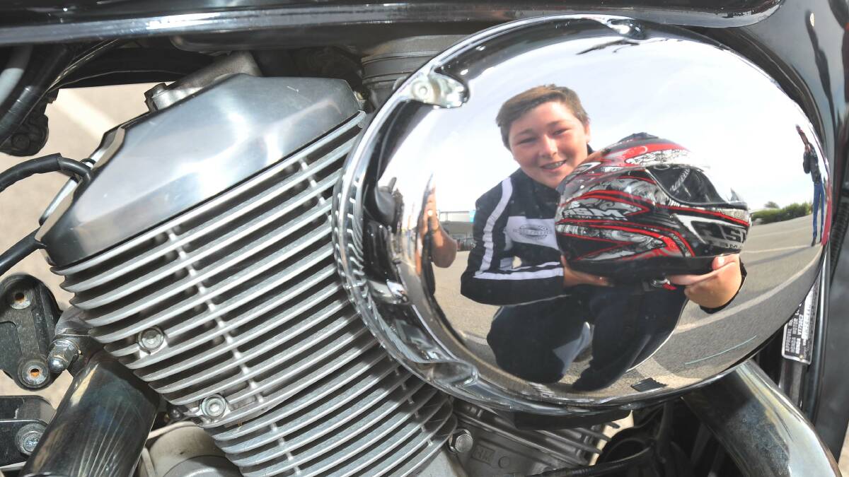 REFLECTION: Aaron Harpley, 14, from Wagga checks out his family's Honda Shadow 750 during yesterday's Black Dog Ride One Dayer. Picture: Kieren L Tilly