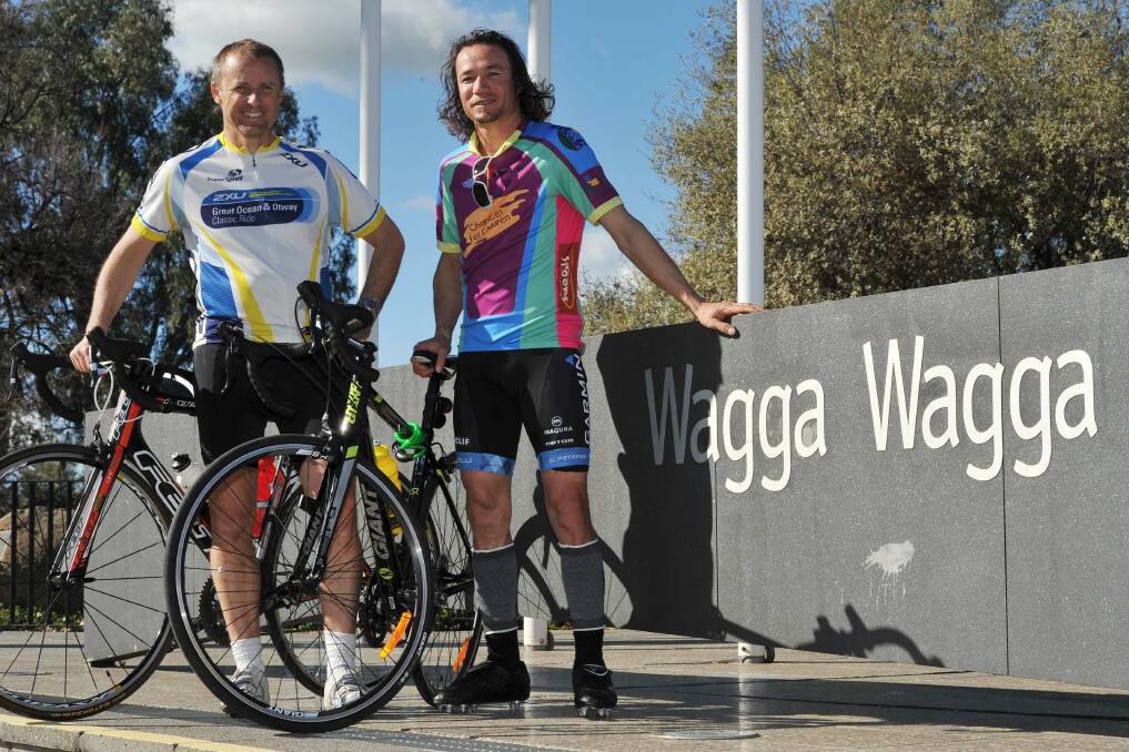 Swan Hill deputy mayor Michael Adamson (left) and Afghani asylum seeker Rohullah Hussaini are riding from Swan Hill to Canberra to raise awareness of refugee rights. The pair stopped in Wagga on Saturday, where they were met with a sunny welcome at the Civic Centre. Picture: Laura Hardwick
