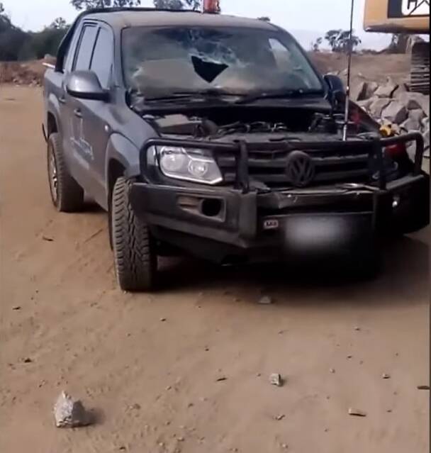 DAMAGE: Large rocks can be seen near a Volkswagen Amarok, which had its bonnet and windscreen damaged after being struck during the explosion. 