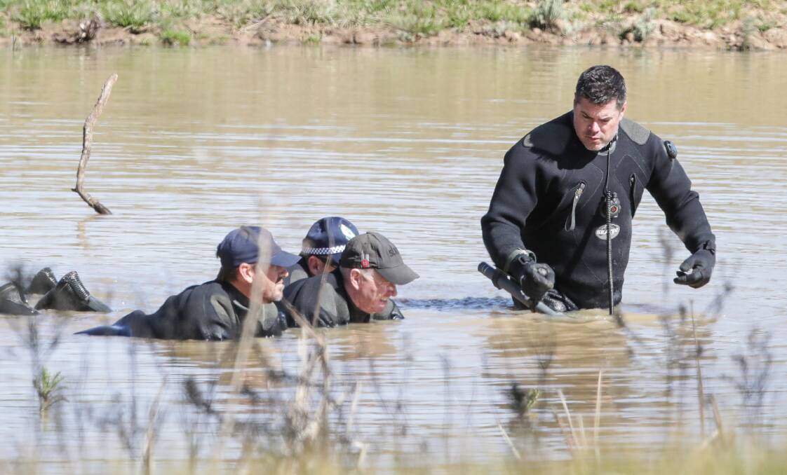 SEARCH: Police divers search a property in Gerogery. 
