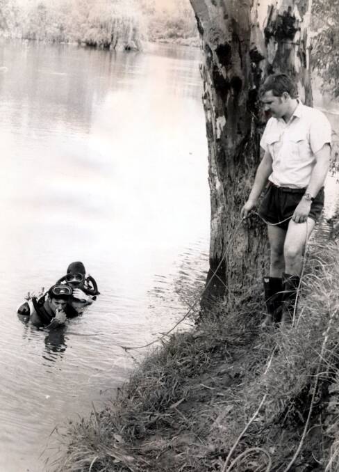 INVESTIGATION: Divers search the Murray River following the murder. 