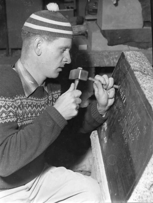 MASTER AT WORK: Stonemason chiselling headstone (RW1574.675).