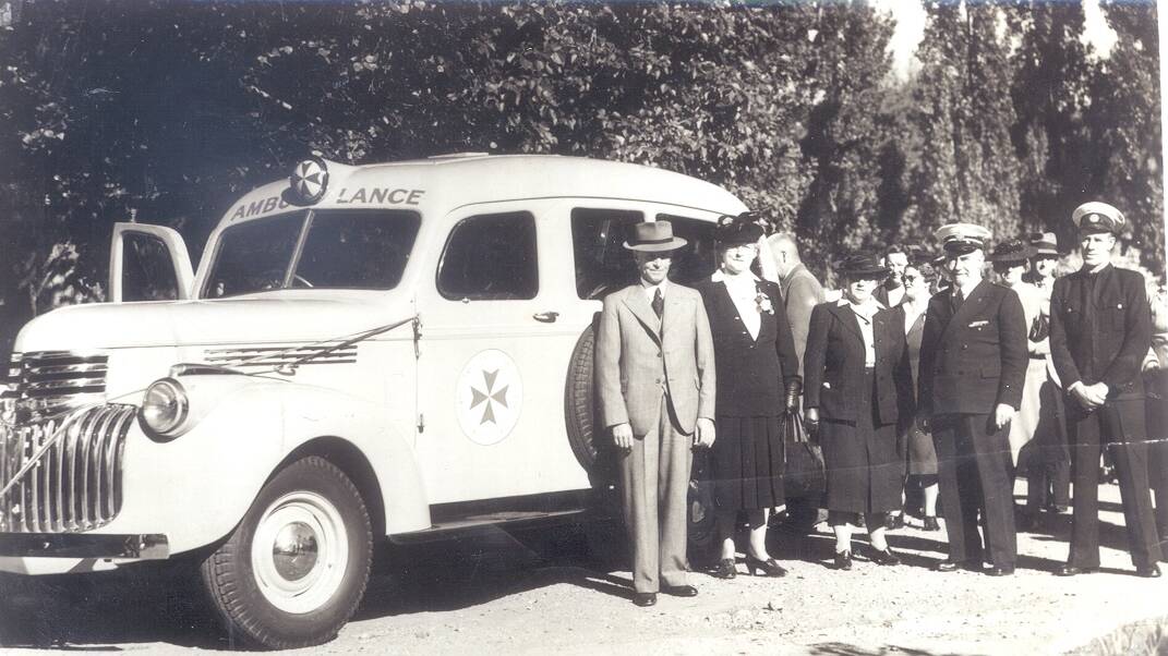 PRESENTED: Ambulance presented to HP Paul, president of the Wagga Ambulance Committee, by 2WG Womens Club President, Cobby Webb, and Mrs Brentnall, 1948. Photo: Sherry Morris Collection.