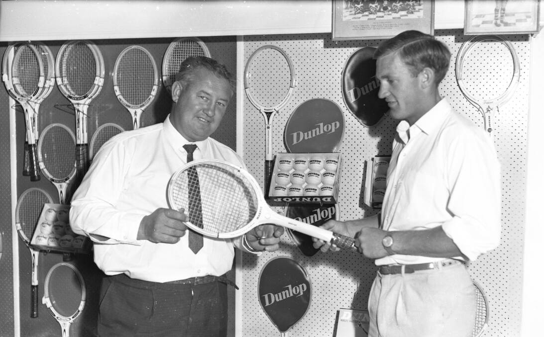 RAISING A RAQUET: Bill Williams in his Sports Store Wagga. Picture: CSURA Lennon Collection RW1574.245