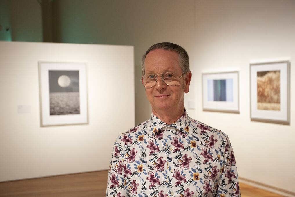 MOMENT IN TIME: Joel Markham with his solo exhibition Heaven and Earth, 2019. He will be part of a panel discussion on the evolution of photography at the gallery on December 7. Picture: Wagga Wagga Art Gallery.