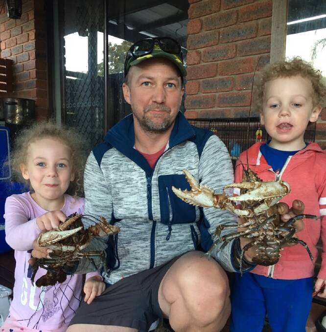CRAY TIME: Justin Knobel, with Grace (left) and Eli (right), has had a good run, catching these crays. 