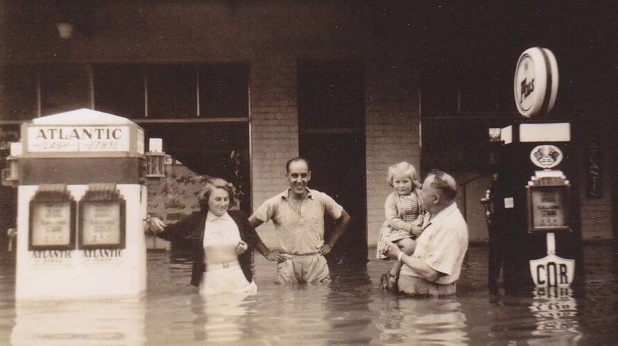 FLOODING: Linda Douglas, Brian Cadden, Janne and Les Douglas pictured outside Douglas Body Company, on the corner of Fitzmaurice and Kincaid Streets, during the 1950 flood. Picture: Bob Douglas