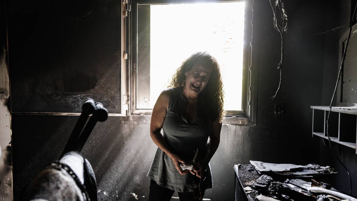 More than three weeks after the Hamas attacks, Israeli Hadas Kalderon, whose children have been taken hostage and her mother and niece killed, breaks down as she looks through the burnt-out home of her late mother in Kibbutz Nir Oz, Israel. Picture by Getty Images
