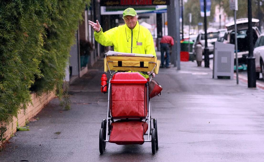 RAIN, HAIL OR SHINE: Wagga postie Eugene Jocic has been with Australia Post for 33 years, delivering mail in all types of weather. Picture: Les Smith