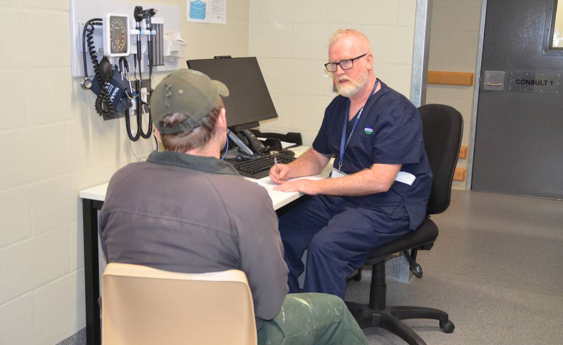 MEANINGFUL WORK: David O'Brien assists an inmate at Junee Correctional Centre in his role as a mental health nurse. Picture: Contributed