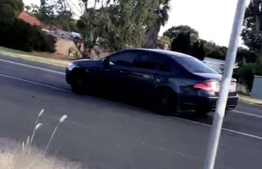 ON LOOK OUT: Police are looking for the driver of the black Ford sedan pictured after reports he appraoched three young girls. Picture: Contributed