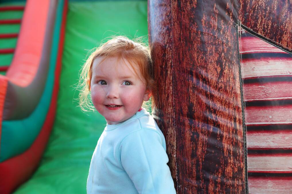 ALL SMILES: 3-year-old Kulan Wheatley goes for a bounce, climb and slide with the jumping castle all to herself. Picture: Emma Hillier