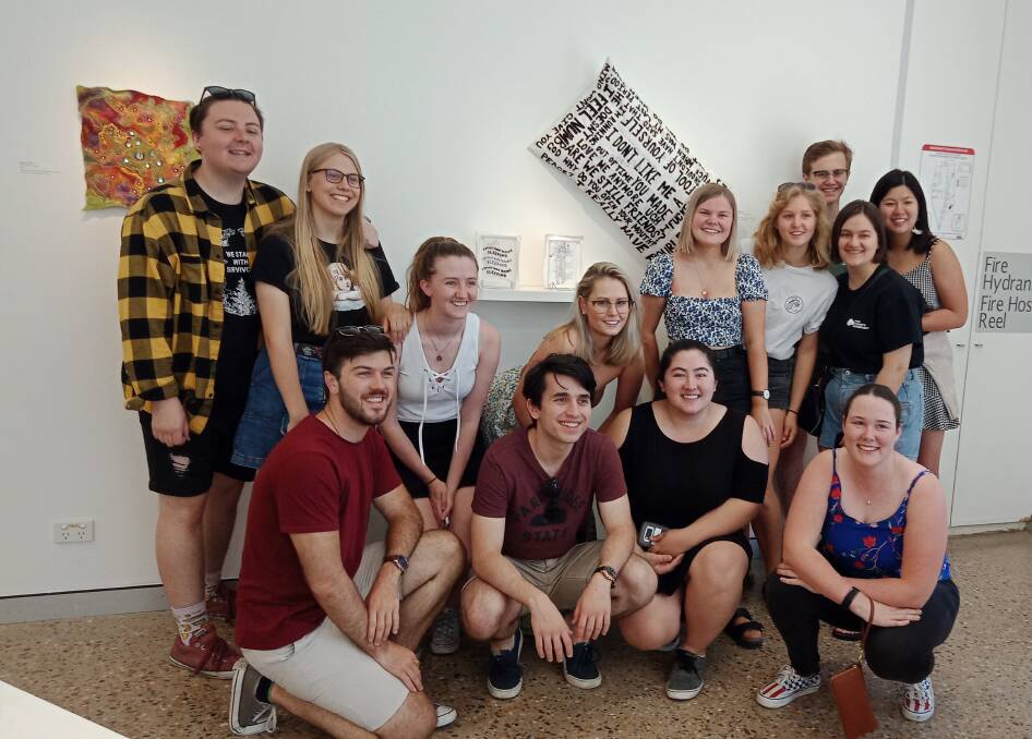 BIGGEST FANS: A crew of Abbie Holbrook's friends and family are thrilled to see her artwork in person at an exhibition, showing their support. Picture: Contributed